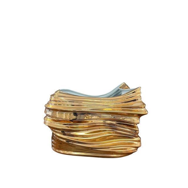Elevate your space with this contemporary porcelain vase, beautifully finished with luxurious 24K gold detailing. Its...