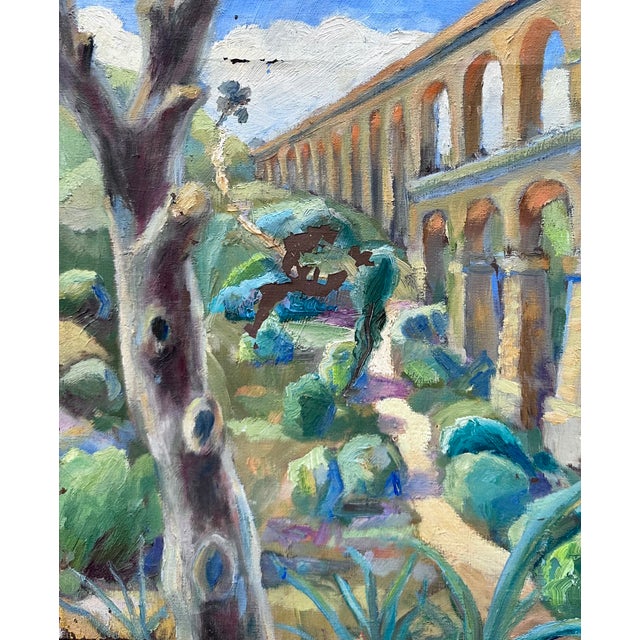 Oil painting on canvas of an ancient Roman aqueduct in Spain, surrounded by vibrant local flora. The artwork has a...