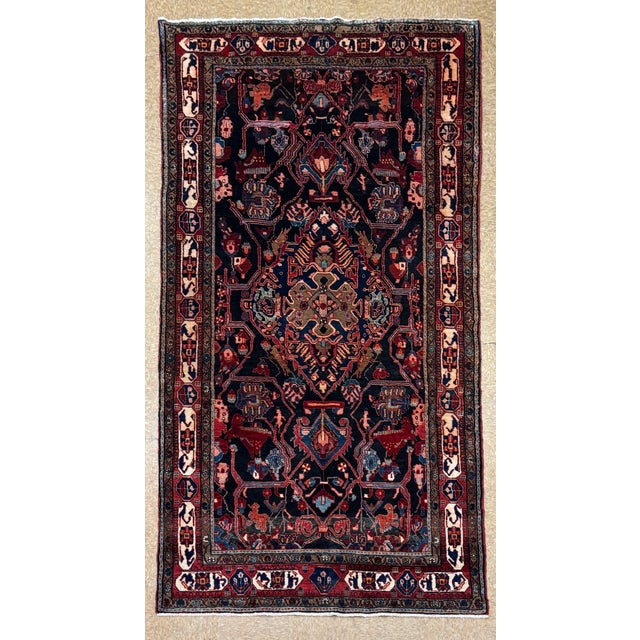 Antique hand-knotted runner from the Nahavand region of western Iran, featuring a complex geometric medallion design on a...