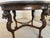 Stunning carved mahogany lion leg center table with glass top insert. Four dramatically carved legs each feature a fully...