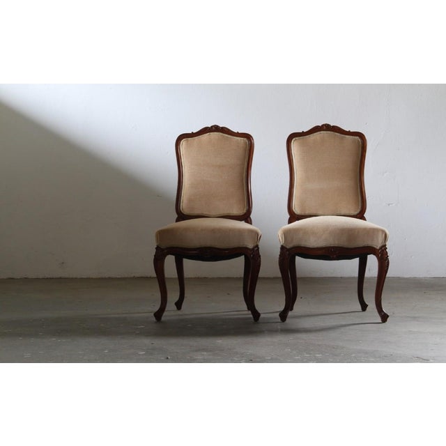 This elegant pair of hand-carved and decorated wooden rococo Lounge Chair from the mid-18th century embody that timeless...