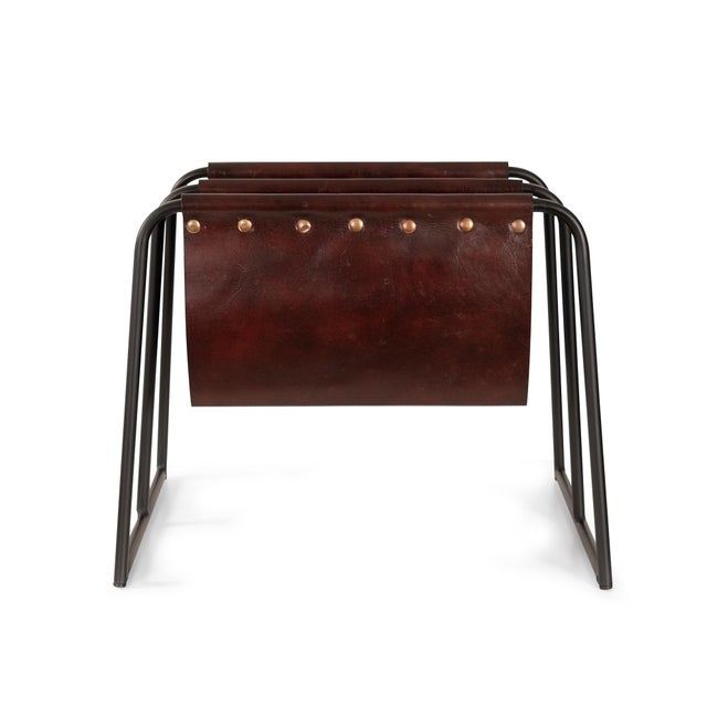 This modern magazine rack combines sleek design with everyday functionality. Crafted with a sturdy black metal frame and...