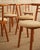Set of six Italian wooden chairs featuring clean lines. Each wooden element is rounded at the ends, and the seat—also...