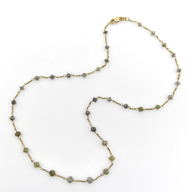 This stunning gray diamond 18k gold necklace features 34 faceted diamond beads. The beads are oblong in shape and...