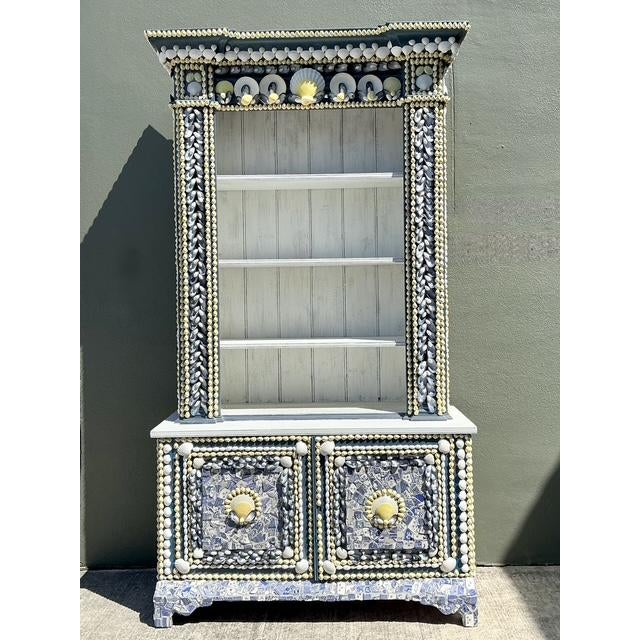 Transform your coastal retreat or maximalist sanctuary with this extraordinary vintage shell-encrusted etagere. A...