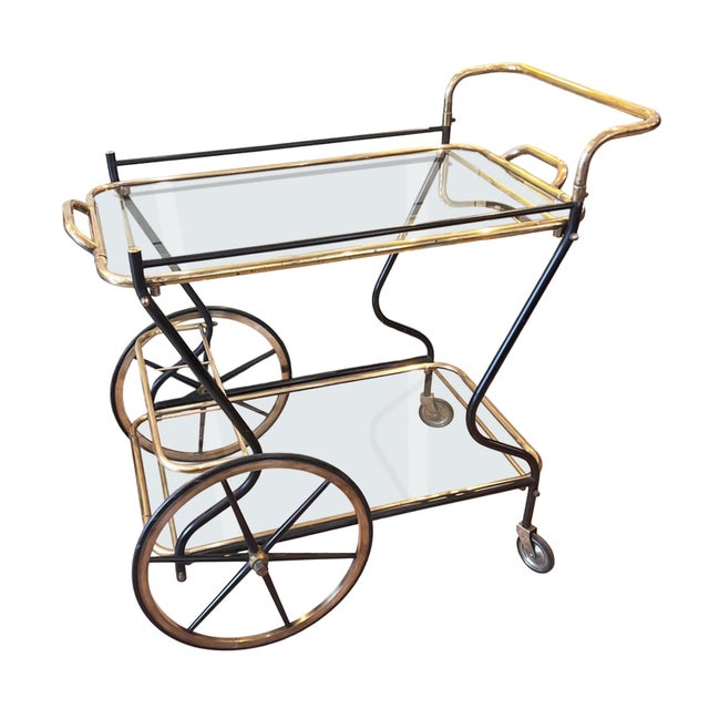 This is a very stylish midcentury bar cart. It was made in Italy in the 1950s from metal and brass. The top trays lift off...