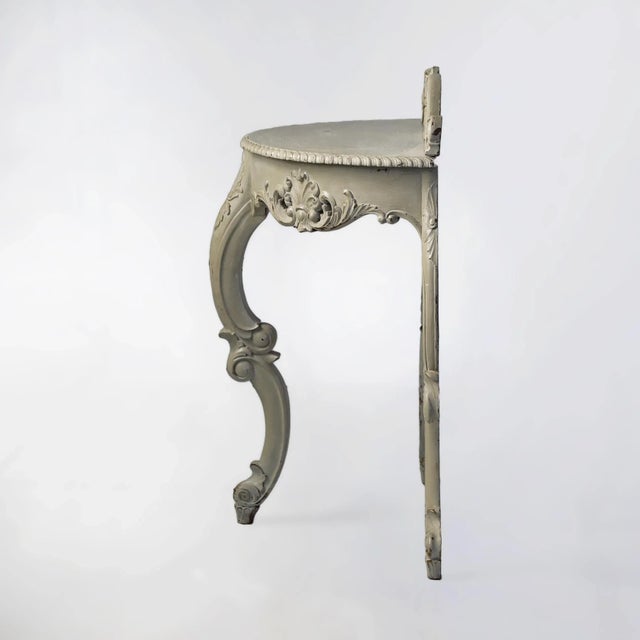 Pair of antique European demilune tables in French gray over gilt wood. May be used with or without decorative back piece.