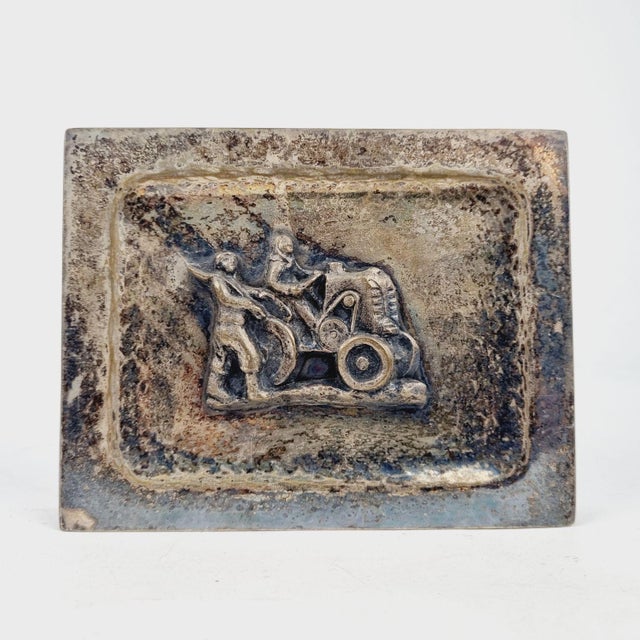 A striking vintage metal decorative box, ideal for use as a cigarette holder, jewelry box, or trinket case. The...