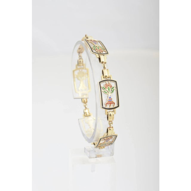 Italian 14K gold bracelet containing five cloisonné polychrome enamel plaques with lotus coming out of a vase design....