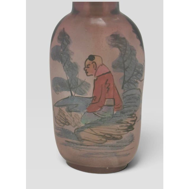 A finely detailed early 20th‑century Chinese inside‑painted snuff bottle, skillfully reverse‑painted through the narrow...