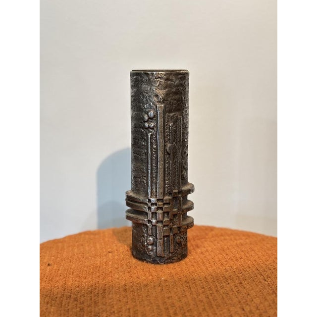 Experience the elegance of Scandinavian design with this exceptional Brutalist stainless steel vase sculpted by Olav Joff....