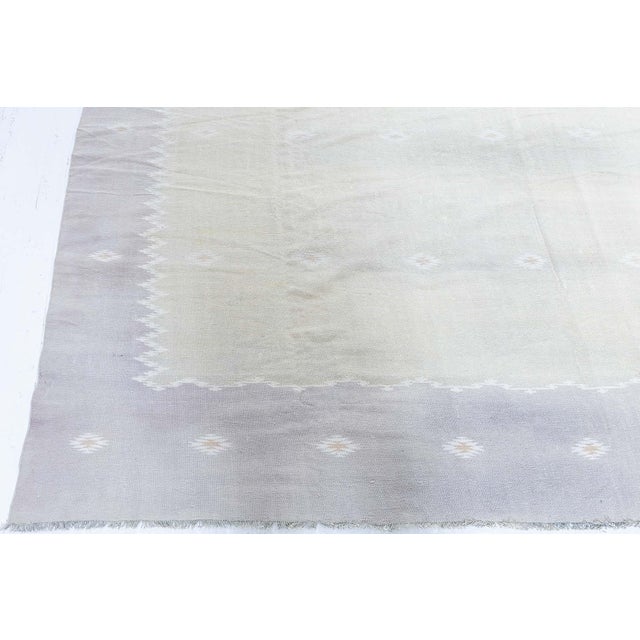 This 1950s Indian Dhurrie rug presents a refined and understated interpretation of traditional flatweave craftsmanship,...