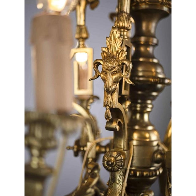 Five-arm bronze chandelier decorated with rams' heads. Very high-quality design from the 19th century. The chandelier is...