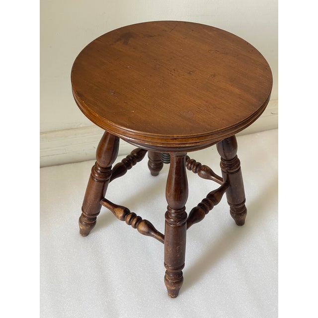 American folk art round table or piano stool 14” in diameter, on 4 spindle legs.