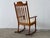 A masterful oak rocking chair — the celebrated "Razorblade" model — by Danish designer Henning Kjærnulf, representing one...