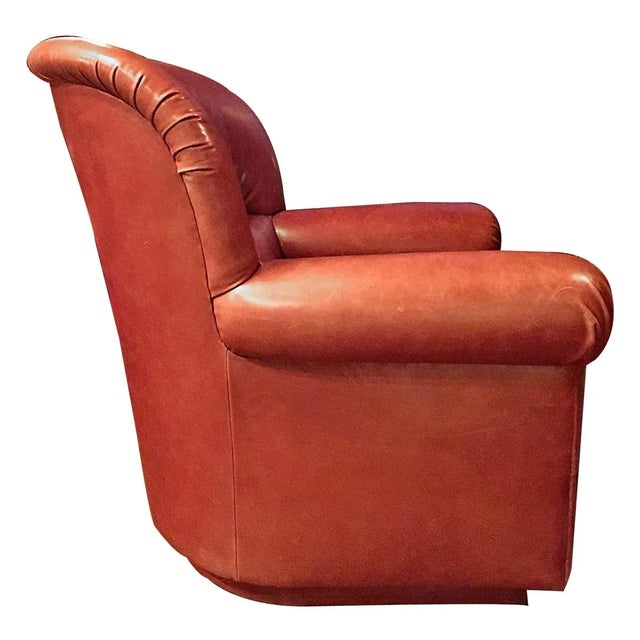 A pair of leather club chairs made by Cameron retailed by Holly Hunt. Upholstered in a soft red brick-colored full grain...