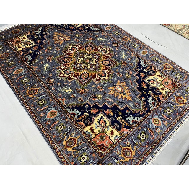 Bring rich color and bold pattern to your space with this blue Afghan Sultani wool area rug, made with natural dyes and a...