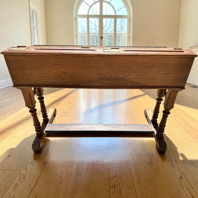 A striking and highly functional 19th-century Gothic Revival twin slant-lid desk, expertly crafted from solid quarter-sawn...