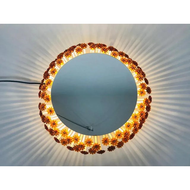 An illuminated wall mirror from the 1960s made in Austria. It was designed by Emil Stejnar for Rupert Nikoll. The mirror...