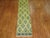 A borderless runner made from a large vintage Turkish runner in predominant shades in yellow and green. Measures: 2'6” x...
