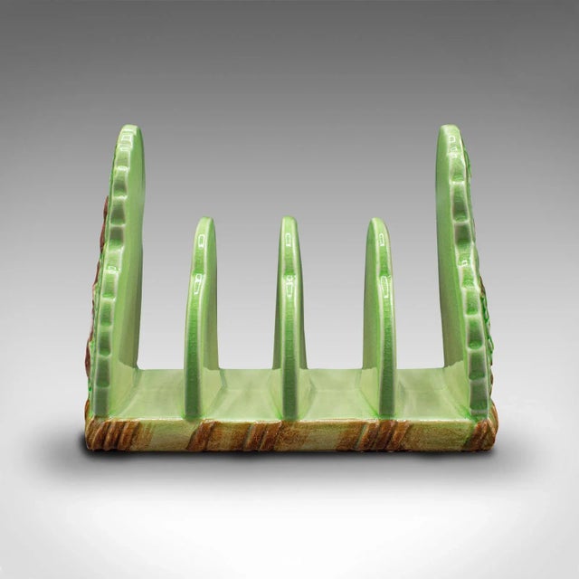 This is a vintage decorative breakfast stand. An English, ceramic 4-slot toast rack, dating to the mid 20th century, circa...