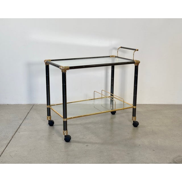1970s bar trolley, metal and brass structure, glass shelves, height at the top 68cm.