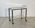 1970s bar trolley, metal and brass structure, glass shelves, height at the top 68cm.