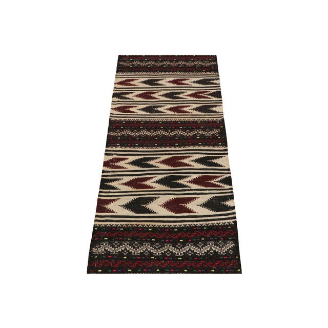 Handwoven in wool, this 2x4 vintage Afghan kilim rug originates circa 1950-1960—a tribal curation among new additions to...