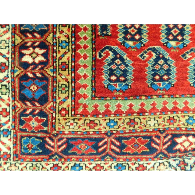 Vintage colorful and rich in tone Turkish prayer rug. Paisly pattern on energetic and vibrant red field within blue...