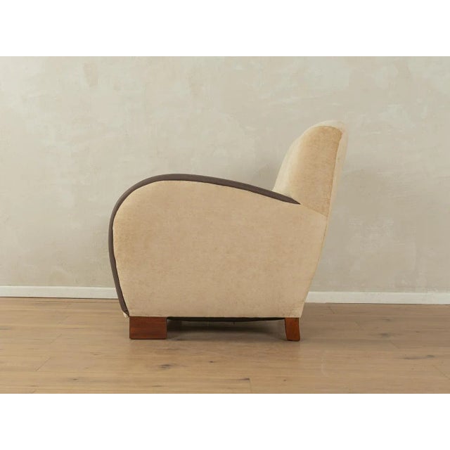 Wonderful Art Deco armchair from the 1930s. High-quality solid wood frame. The original spring core has been reupholstered...