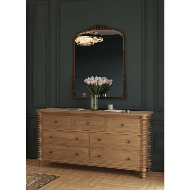 The dresser, finished in light fruitwood, combines classic American style with a modern look. Its spool turned details and...