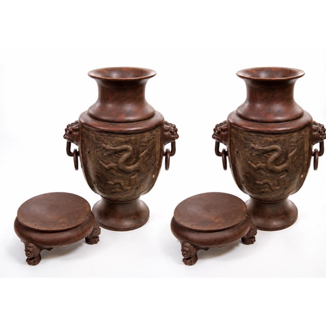Impressive pair of antique Chinese bronze vases, dating to the late 19th to early 20th century, each featuring an...