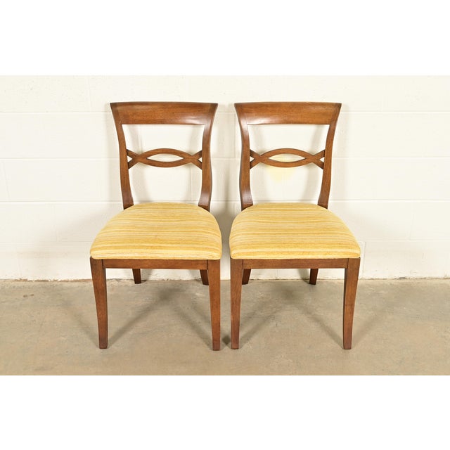 A gorgeous pair of Regency style side chairs or dining chairs In the manner of Kindel Furniture USA, Circa 1960s Carved...