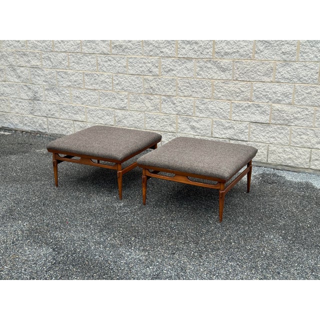 Substantial pair of vintage Lane ottomans with beautifully constructed walnut frames and newly upholstered seats....