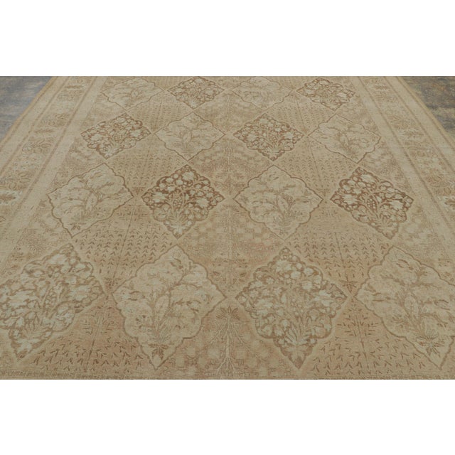 This 10x13 antique Tabriz rug, circa 1900–1920, represents a sophisticated entry in our Persian collection—an early 20th-...