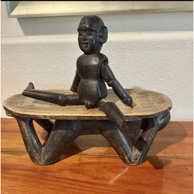 Hand carved wood African figure laying down holding a wood tray on its back. Perfect for placement on top of a dresser to...