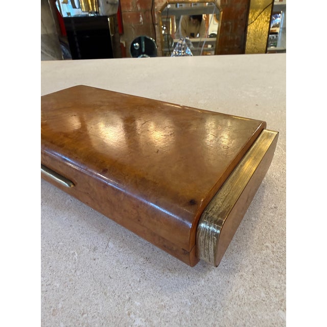 Elegant vintage Italian desk box crafted in warm burl wood with refined brass accents on each side. The gently curved top...