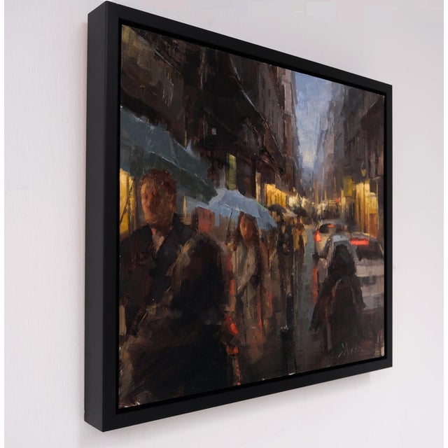 The artwork captures a bustling Madrid street scene enveloped in the soft glow of evening light, where figures navigate...