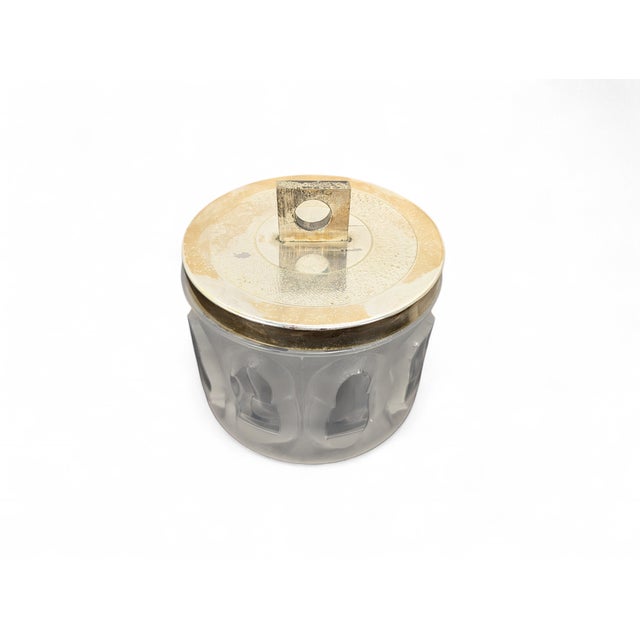 This refined container stands out for its heavy crystal body, skillfully crafted with alternating satin finishes and deep,...