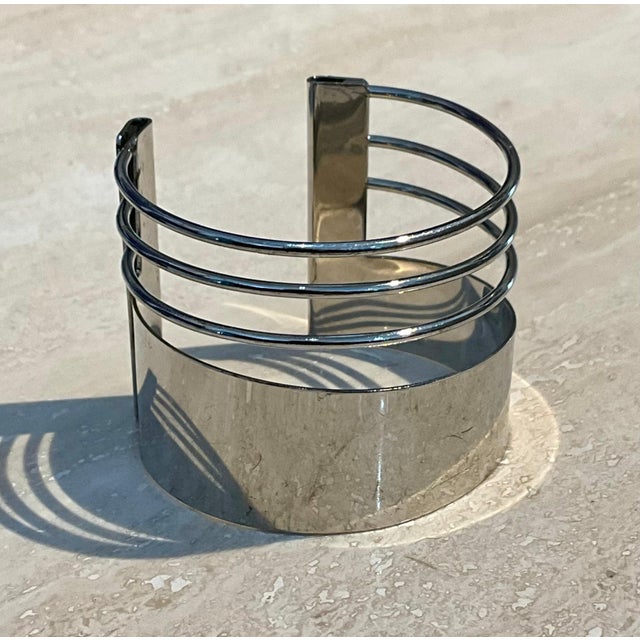 This vintage silver minimalist adjustable cuff bracelet is a study in understated elegance. Defined by clean lines, a...