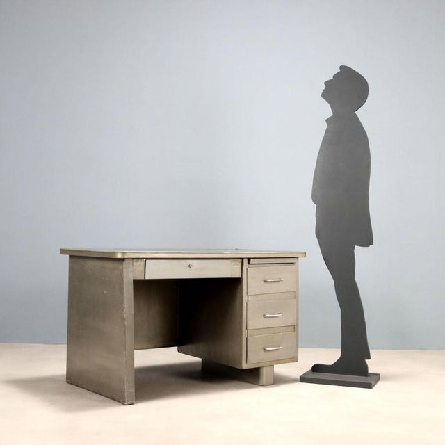 Vintage metal desk with green enamel top, small drawer under the top and a row of three side drawers. This piece is...