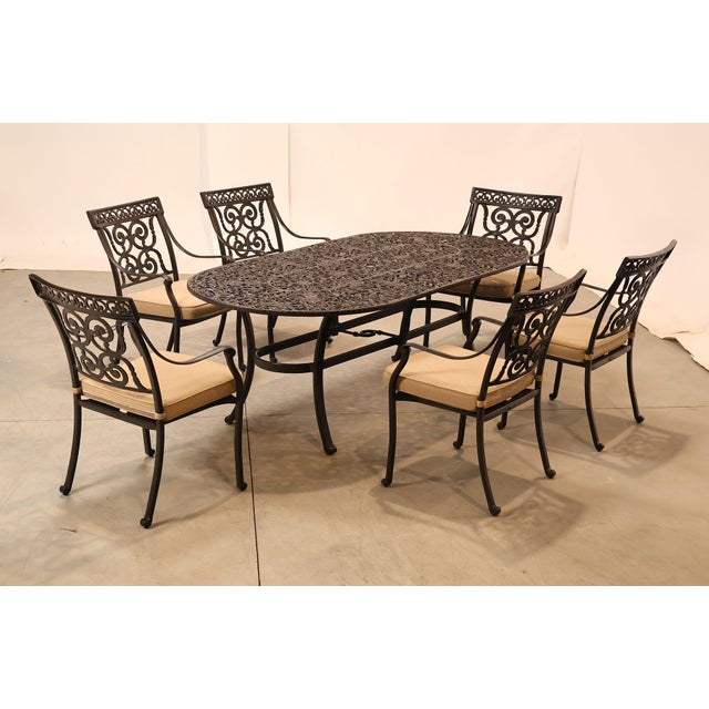 High Quality Outdoor Dining Set Featuring Cast Aluminum Construction With Oval Dining Table And Six Arm Chairs. Decorated...