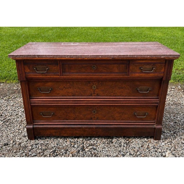 A beautifully crafted American Victorian dresser dating to approximately 1895–1905, showcasing richly figured walnut burl...