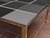 This square coffee table features a stunning gray and black Murano glass top, elegantly set in a durable brass frame....