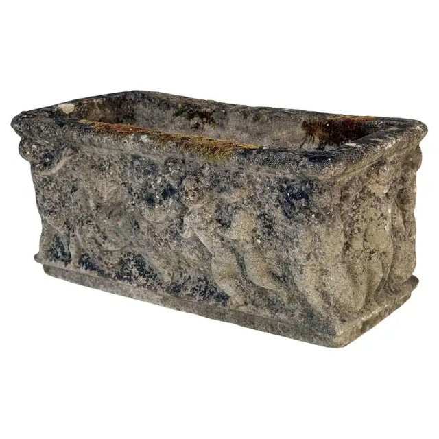 A fine English rectangular garden trough of planter with an ornamental Classical relief of cherubs on all four sides. Two...