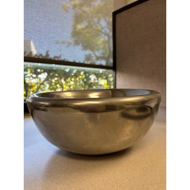 Add a touch of understated elegance to your space with this sculptural silver-tone metal bowl, crafted in India. Featuring...