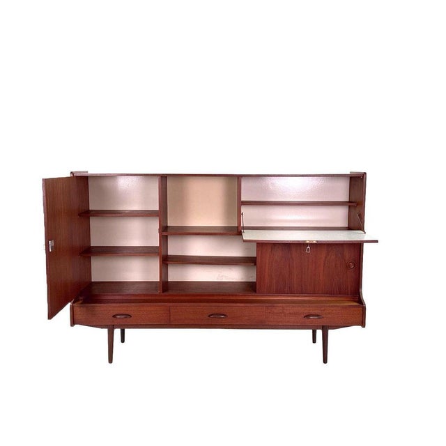 Vintage highboard, produced in the 60s in the netherlands. This highboard offers plenty of storage space, with shelves and...