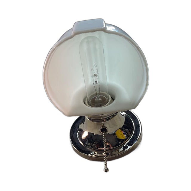 Fine example of a bathroom sconce with milk glass shade. New nickel on fixture and new pull chain socket.