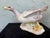 This vintage Italian porcelain figurine depicts a duck in a lively, expressive pose with wings partially outstretched,...