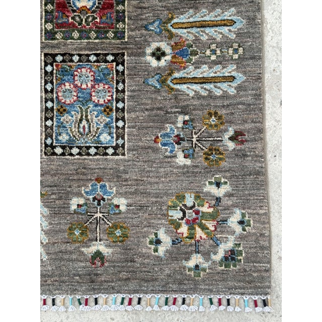 A hand-knotted area rug in the Bakhtiari garden panel design, woven in Afghanistan on a soft grey ground, its field...